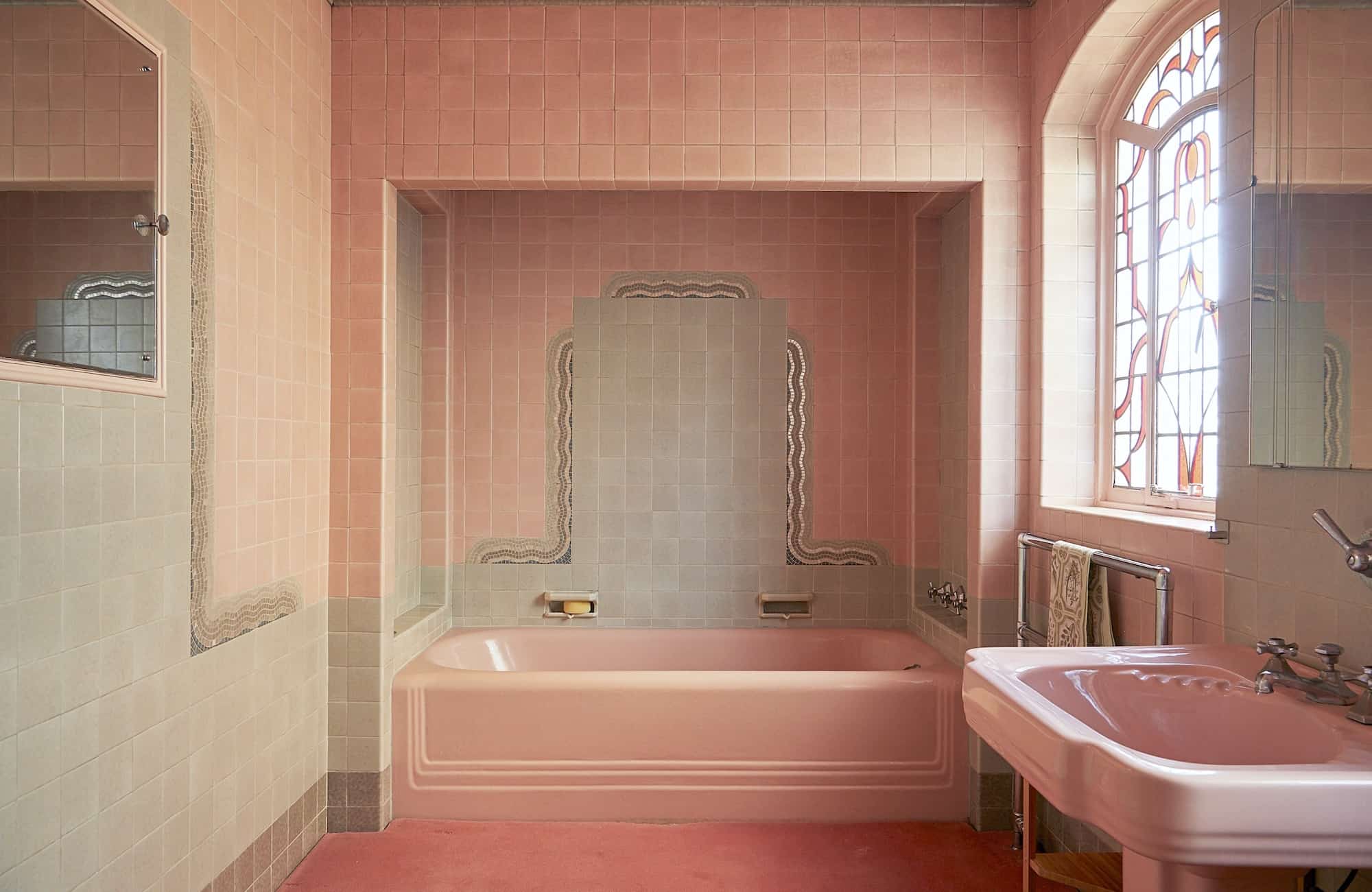 Lillian Nw - Blog Post - Unusual Locations - Pink tiled bathroom with pink carpet on the floor - The Location Guys